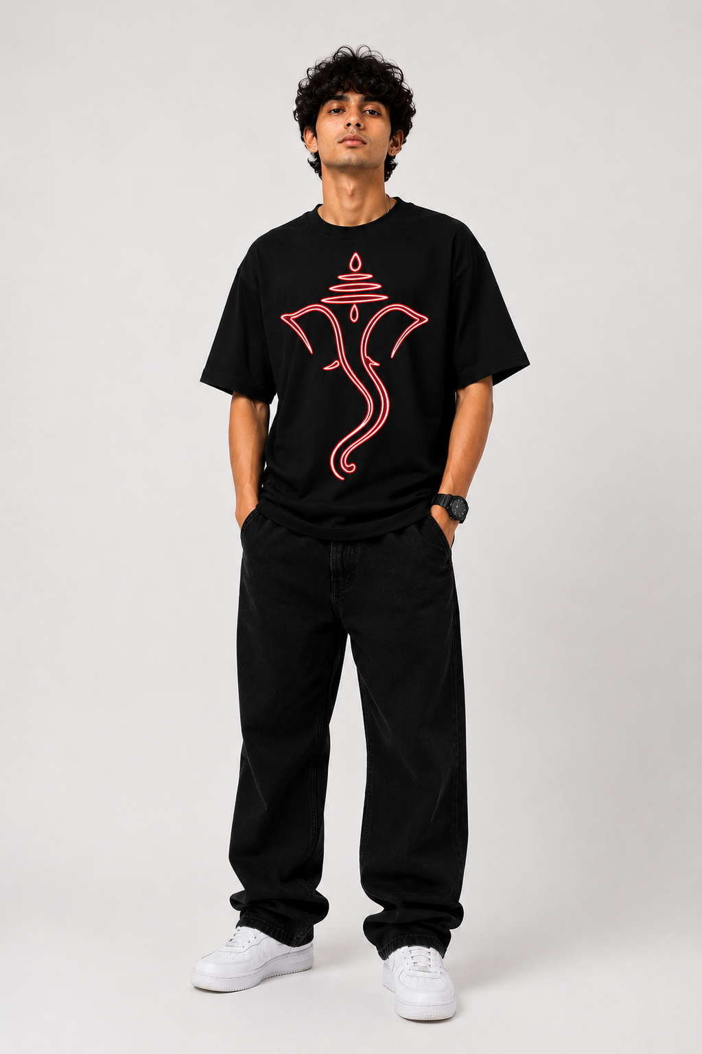 Black oversized graphic T-shirt from the StitchVaults™ GANESHA LEGACY™ Collection featuring a minimalist red neon line art illustration of Lord Ganesha with a sacred tilak design on the front.