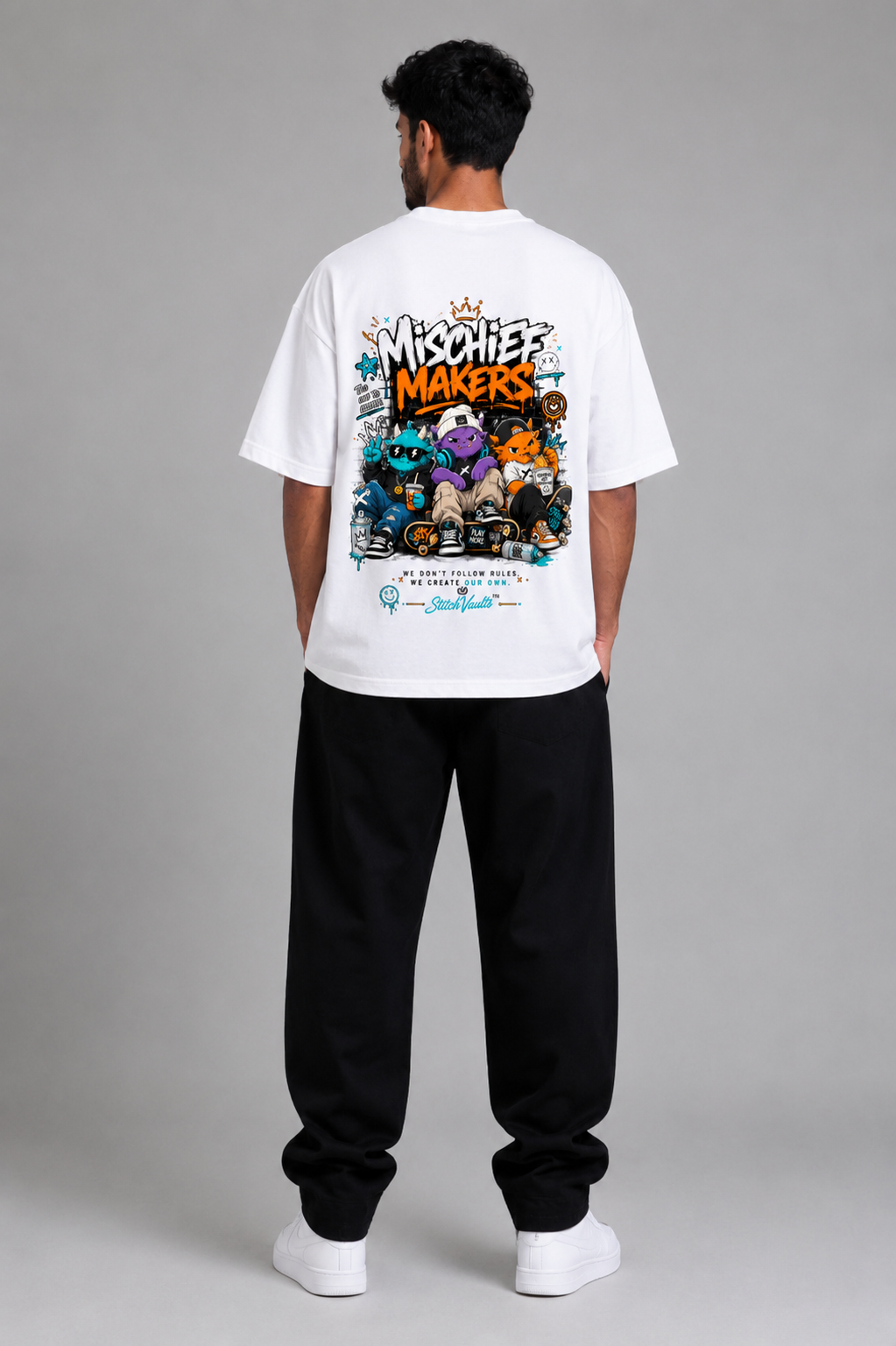 White oversized graphic T-shirt from the StitchVaults™ NOSTALGIA™ Collection featuring the Mischief Makers artwork with playful street-style monster characters, graffiti graphics, skateboards, and nostalgic childhood-inspired streetwear.