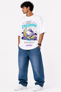White oversized premium cotton T-shirt featuring a cute sleeping cloud resting on a crescent moon with colorful dreamcore artwork, stars, pastel graphics, and the inspirational "Keep Dreaming" message from the StitchVaults™ NOSTALGIA™ Collection.