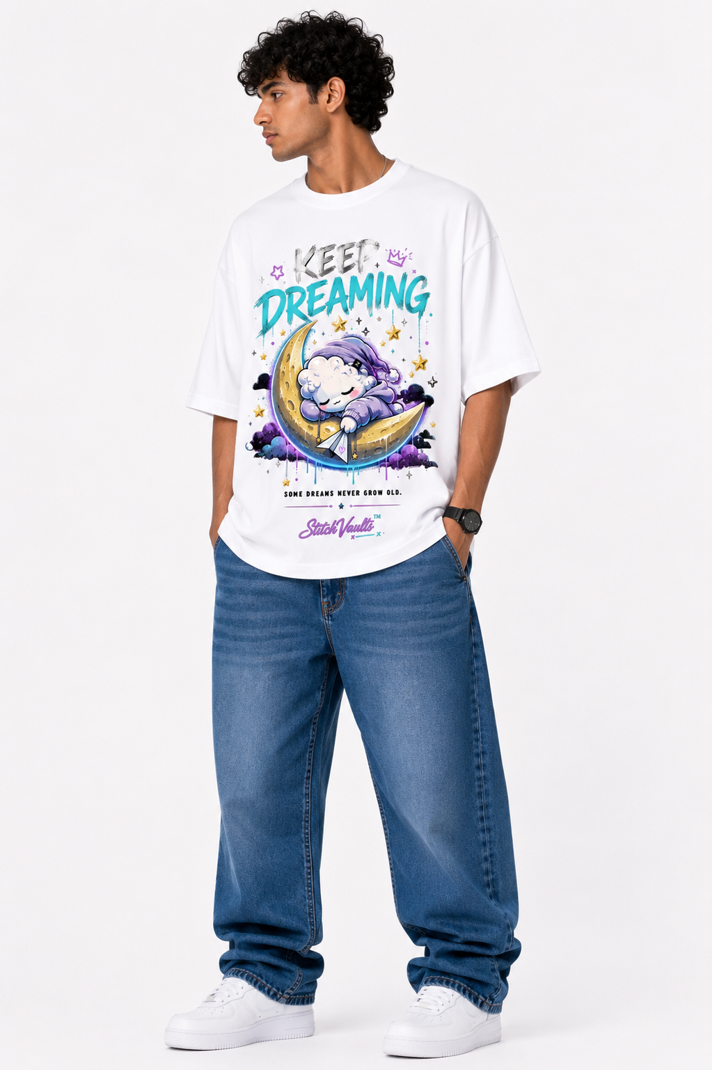 White oversized premium cotton T-shirt featuring a cute sleeping cloud resting on a crescent moon with colorful dreamcore artwork, stars, pastel graphics, and the inspirational "Keep Dreaming" message from the StitchVaults™ NOSTALGIA™ Collection.