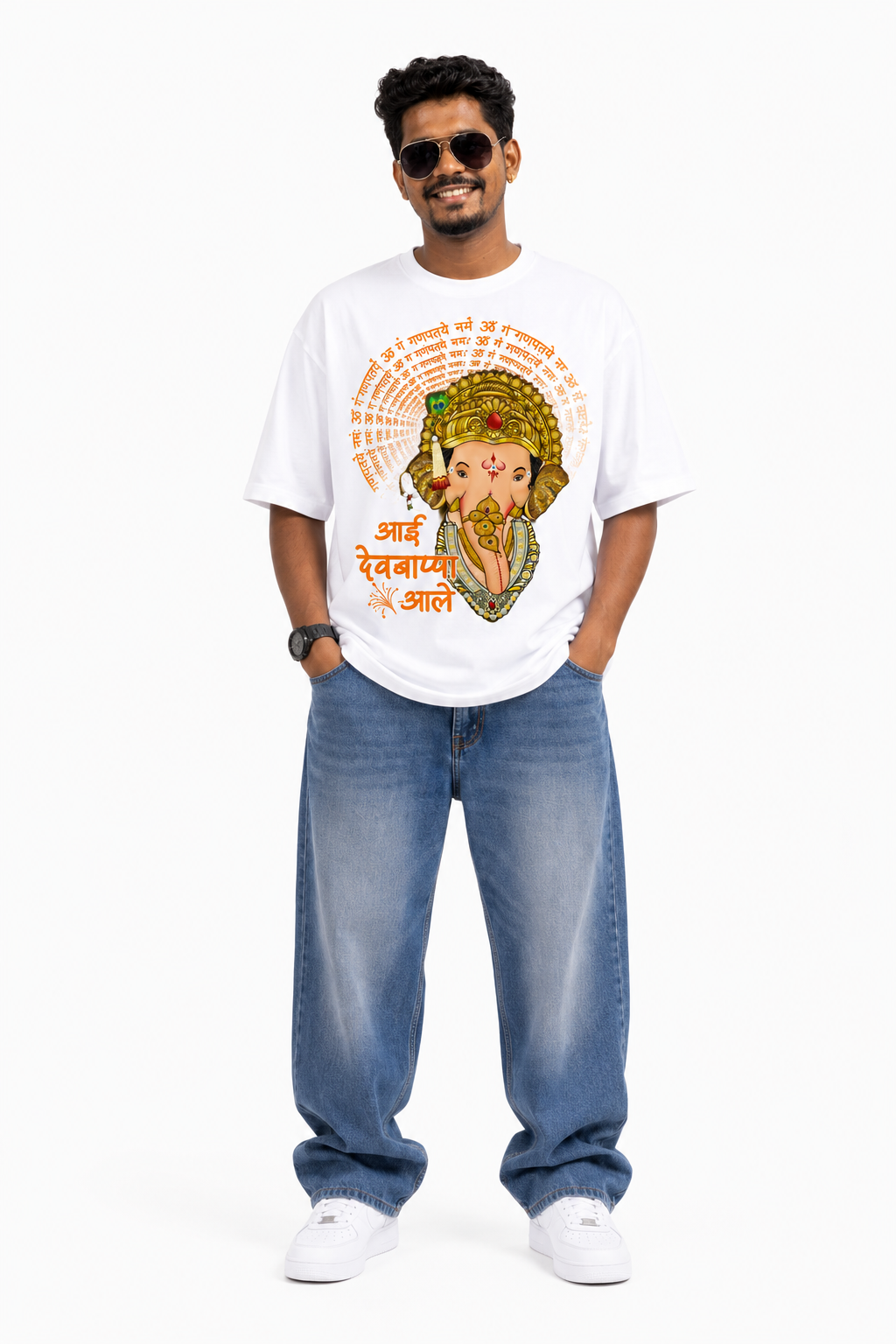White oversized graphic T-shirt from the StitchVaults™ GANESHA LEGACY™ Collection featuring Lord Ganesha surrounded by the sacred "ॐ गं गणपतये नमः" mantra with the Marathi phrase "आई देवबाप्पा आले" in vibrant devotional artwork.