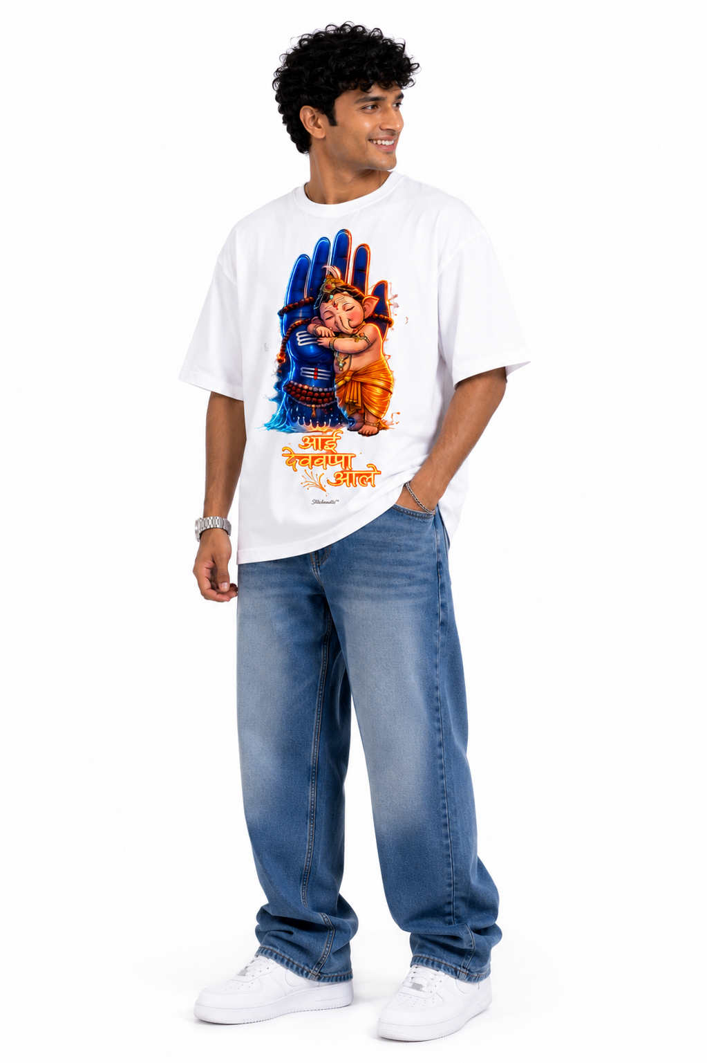 White oversized graphic T-shirt from the StitchVaults™ GANESHA LEGACY™ Collection featuring Baby Lord Ganesha hugging Lord Shiva's sacred hand with the Marathi phrase "आई देवबाप्पा आले" in vibrant devotional artwork.