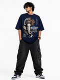 Navy blue oversized graphic T-shirt from the StitchVaults™ GANESHA LEGACY™ Collection featuring a monochrome Lord Ganesha portrait with sacred Om symbol, Sanskrit mantras, and the inspirational quote "Stay Focused, Keep Faith, Let Bappa Handle the Rest."