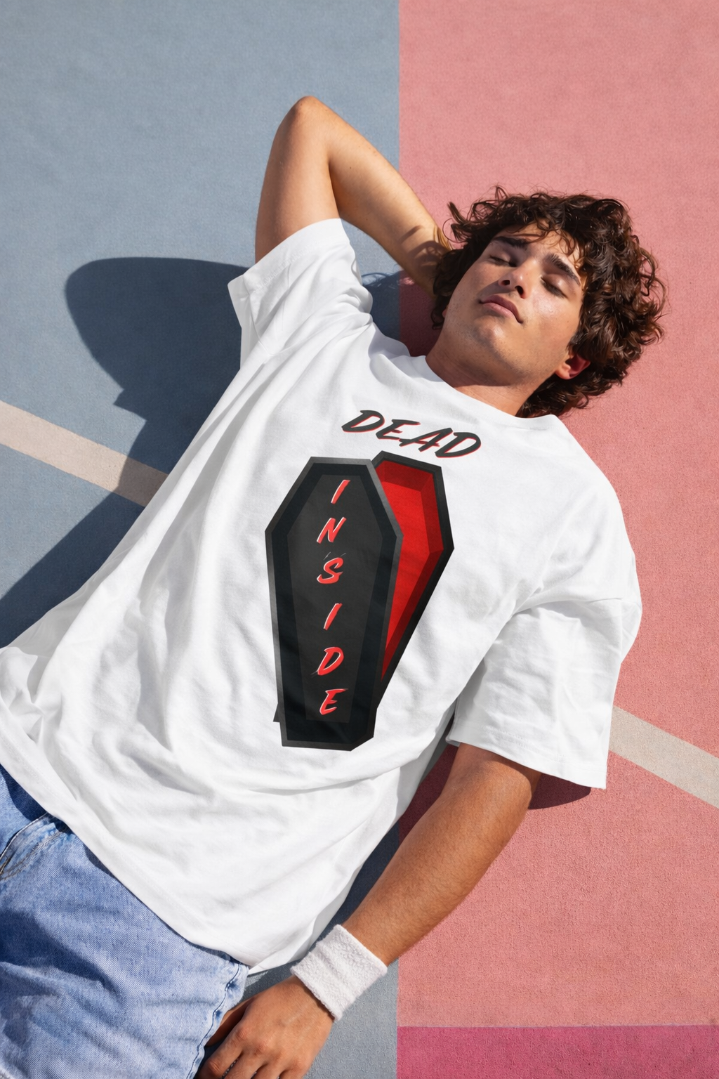White oversized t-shirt with Dead Inside coffin graphic worn by male model streetwear style